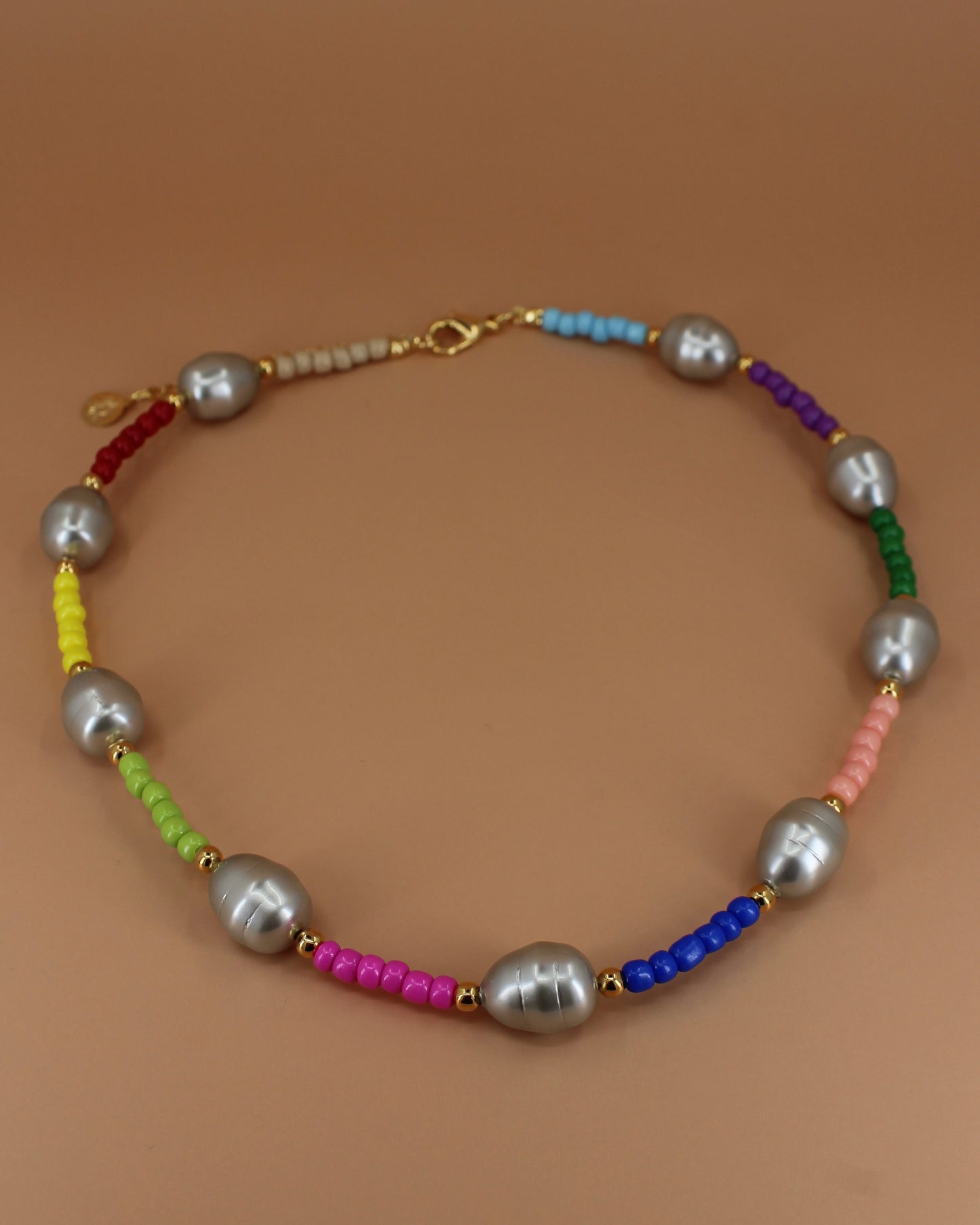 Handmade colorful glass bead necklace with imitation mother of pearls and gold accents, bold statement jewelry by Cuya.