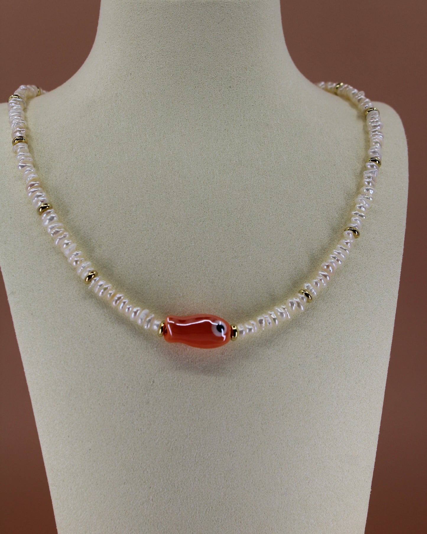 Handmade freshwater pearl necklace with gold accents and colorful glass fish charm, ocean-inspired coastal jewelry by Cuya.