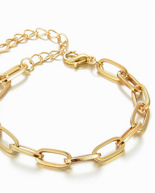A gold-colored bracelet with a chain link design, featuring an adjustable clasp.