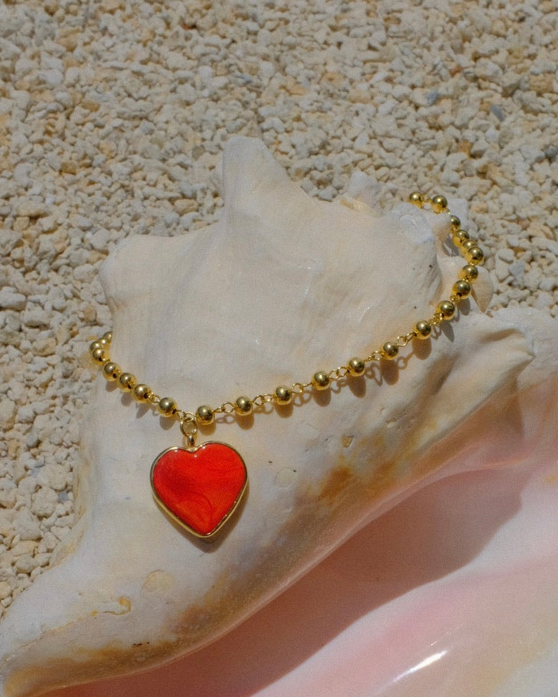 heart pendant necklace, bold gold necklace, colorful charm necklace, trendy heart jewelry 2025, statement necklace for summer, handmade Miami jewelry, red heart necklace, resin pendant necklace