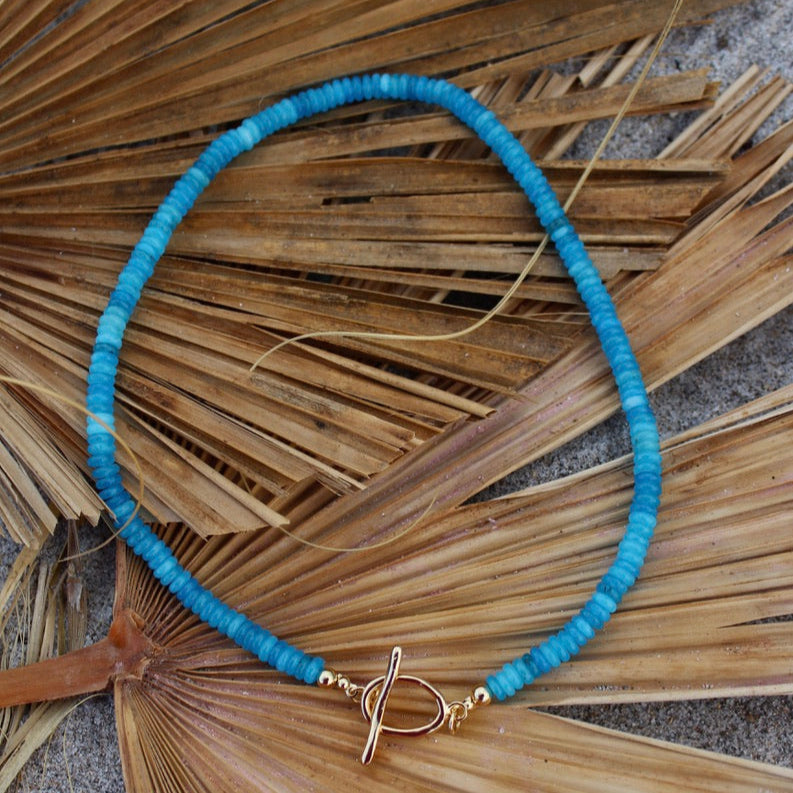 Blue necklace with a gold clasp beachy beachy summer necklace stack trendy style stylish