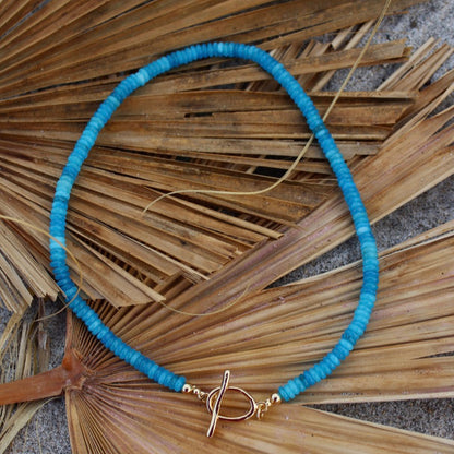 Blue necklace with a gold clasp beachy beachy summer necklace stack trendy style stylish