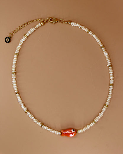 Handmade freshwater pearl necklace with gold accents and colorful glass fish charm, ocean-inspired coastal jewelry by Cuya.
