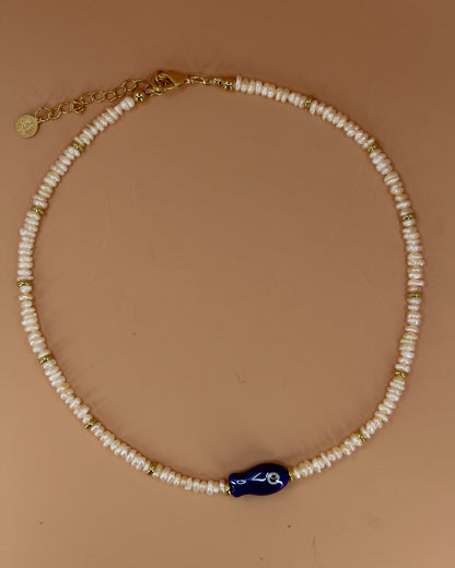 Handmade freshwater pearl necklace with gold accents and colorful glass fish charm, ocean-inspired coastal jewelry by Cuya.