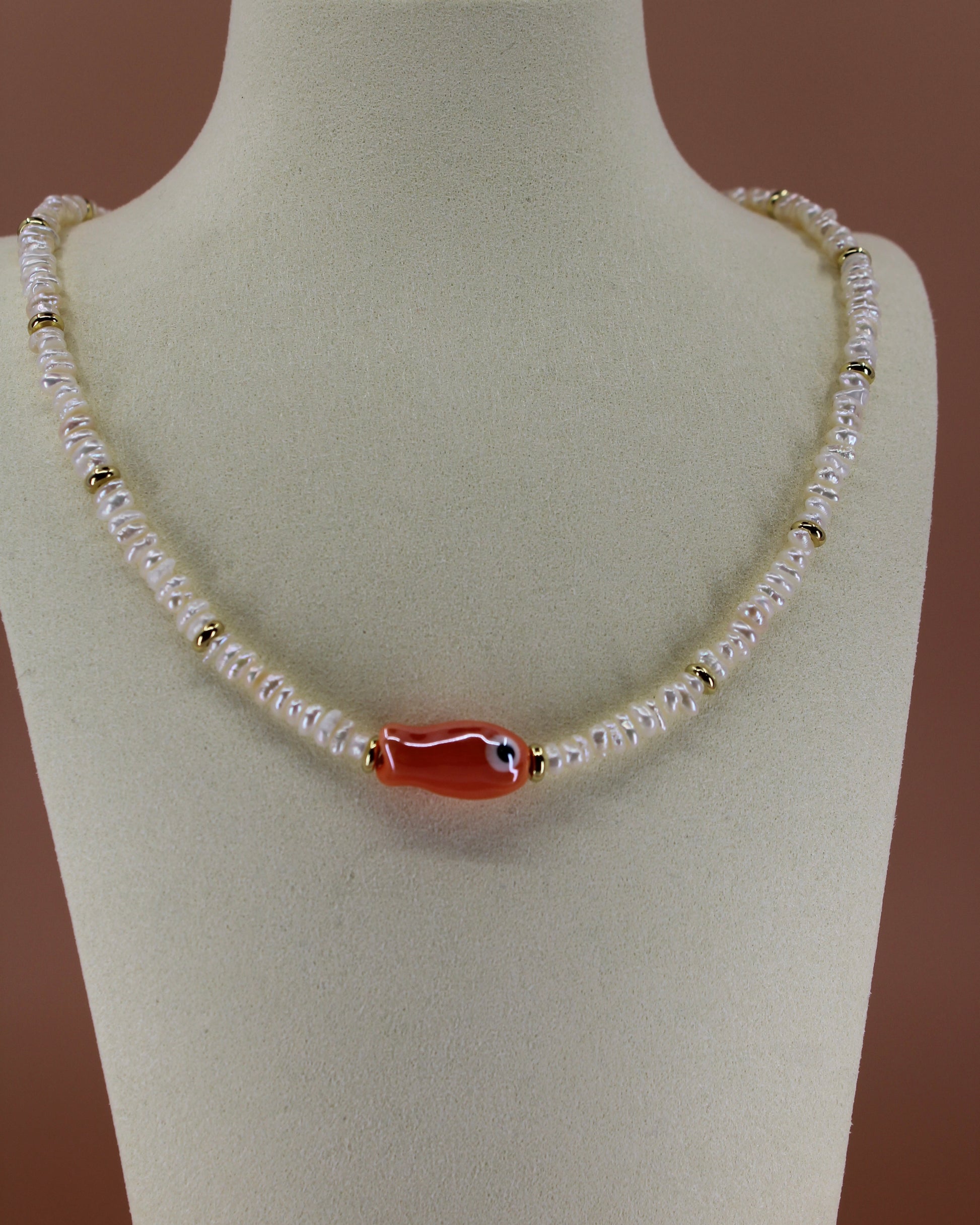 Handmade freshwater pearl necklace with gold accents and colorful glass fish charm, ocean-inspired coastal jewelry by Cuya.