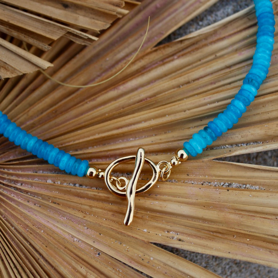 Blue necklace with a gold clasp beachy beachy summer necklace stack trendy style stylish