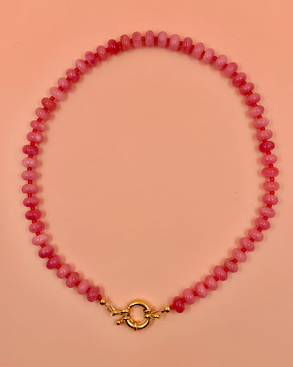 Handmade beaded necklaces in pink with gold sailor clasps for interchangeable charms, customizable coastal jewelry by Cuya.
