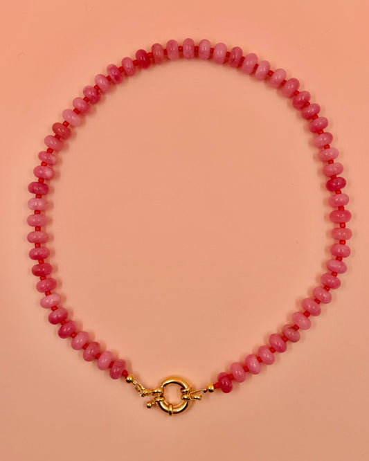 Handmade beaded necklaces in pink with gold sailor clasps for interchangeable charms, customizable coastal jewelry by Cuya.