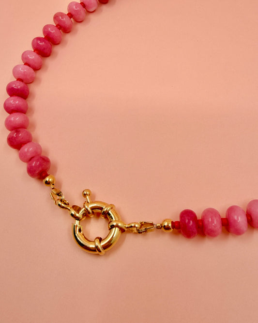 Handmade beaded necklaces in pink with gold sailor clasps for interchangeable charms, customizable coastal jewelry by Cuya.