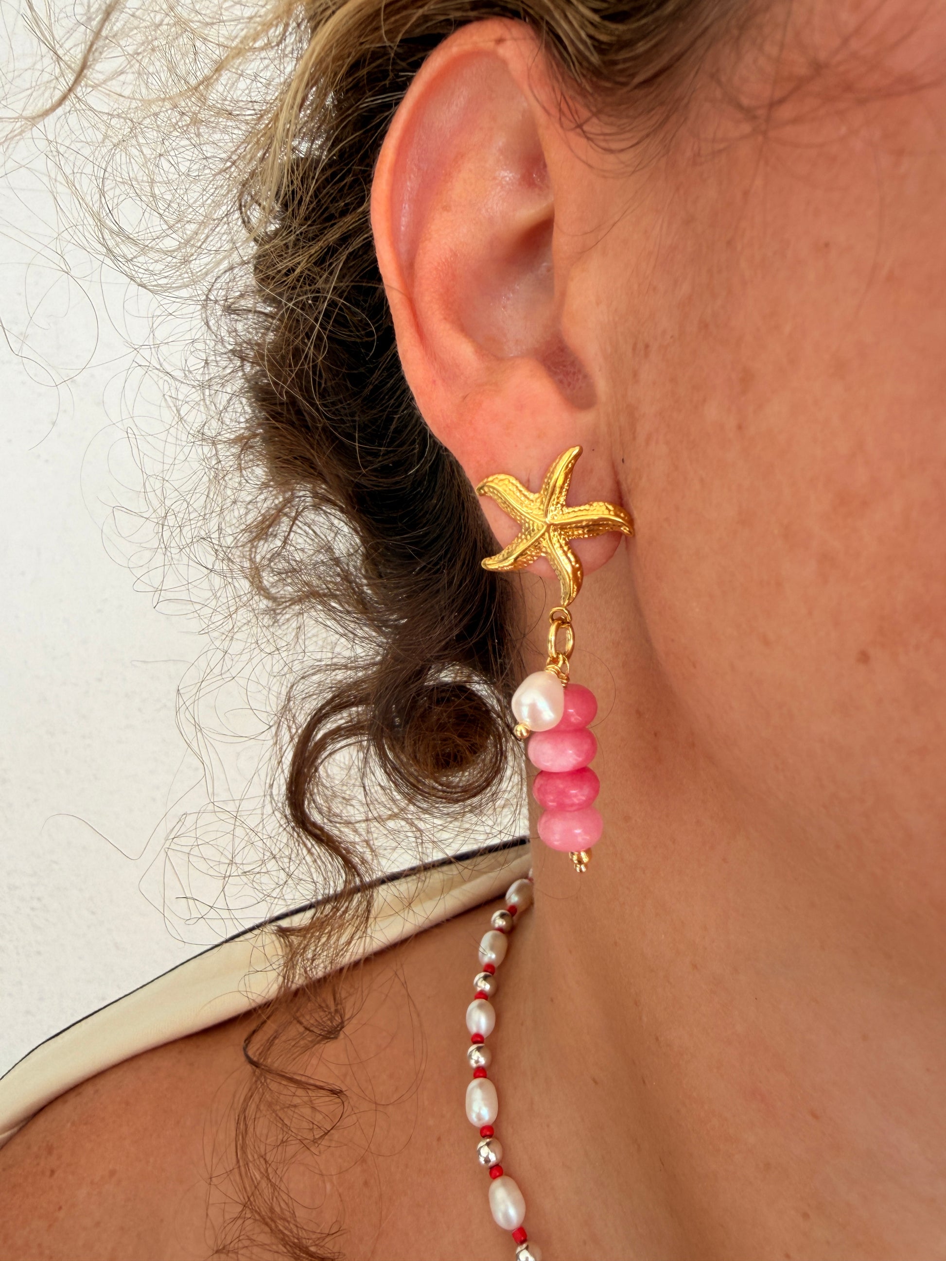 Limited-edition starfish earrings featuring gold-plated stainless steel, jade beads, and freshwater pearls. Handmade in small batches by Cuya Jewelry.