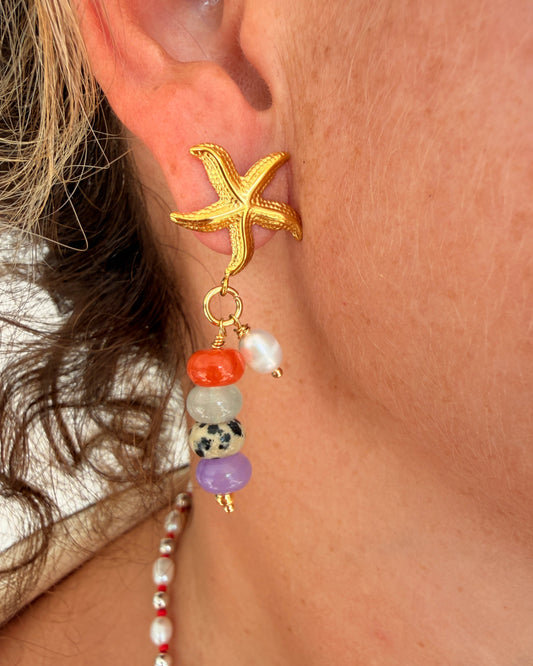 Limited-edition starfish earrings featuring gold-plated stainless steel, jade beads, and freshwater pearls. Handmade in small batches by Cuya Jewelry.