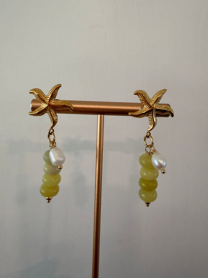 Limited-edition starfish earrings featuring gold-plated stainless steel, jade beads, and freshwater pearls. Handmade in small batches by Cuya Jewelry.