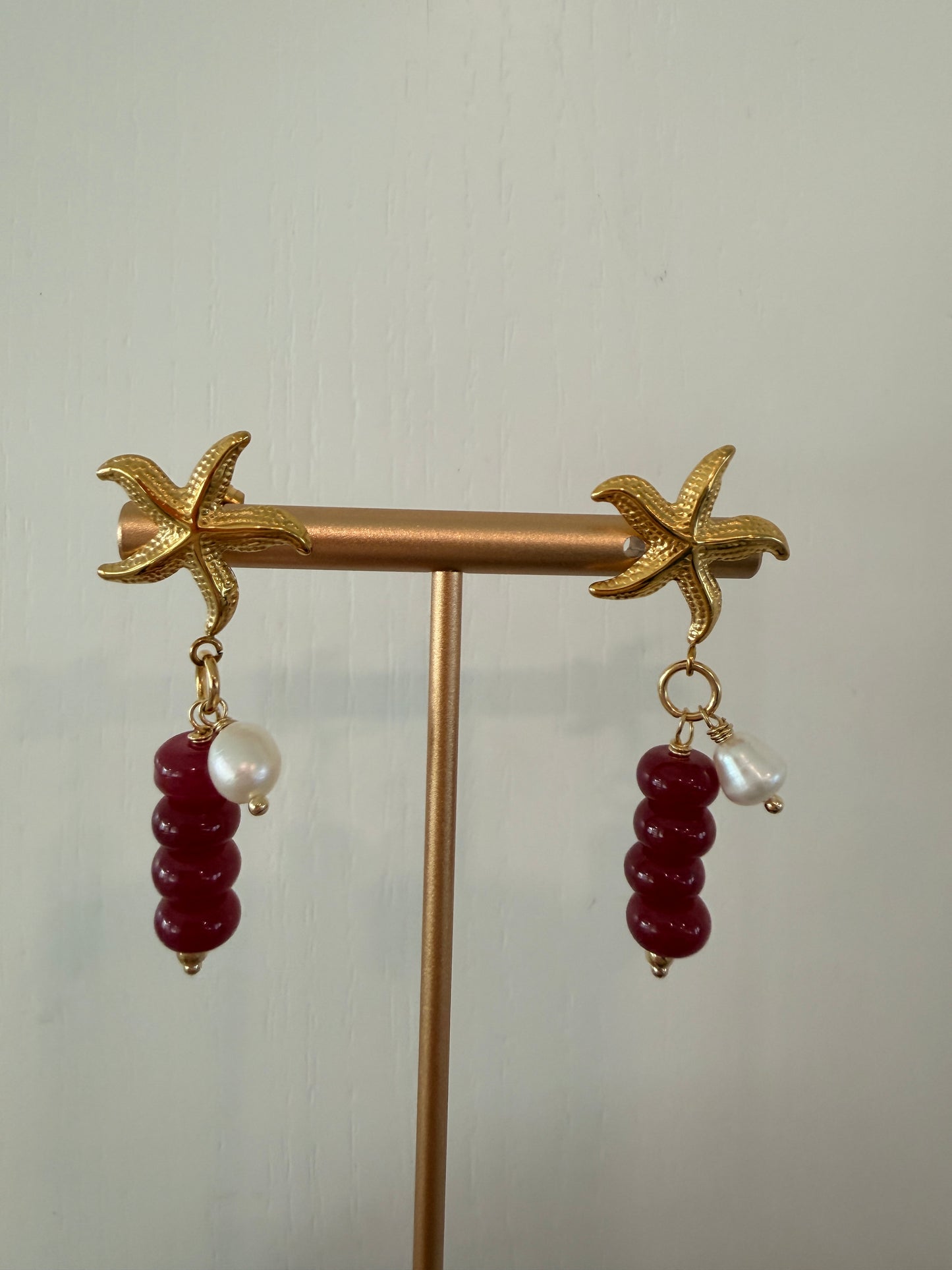 Limited-edition starfish earrings featuring gold-plated stainless steel, jade beads, and freshwater pearls. Handmade in small batches by Cuya Jewelry.