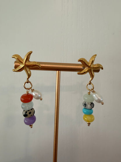 Limited-edition starfish earrings featuring gold-plated stainless steel, jade beads, and freshwater pearls. Handmade in small batches by Cuya Jewelry.